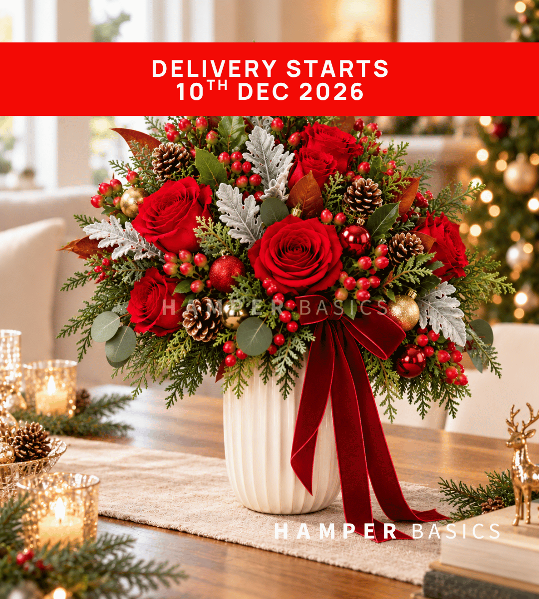 Christmas flower vase arrangement with red roses and festive fillers and foliages