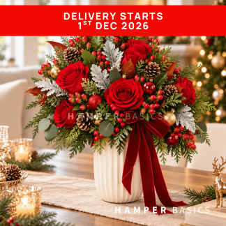 Christmas flower vase arrangement with red roses and festive fillers and foliages