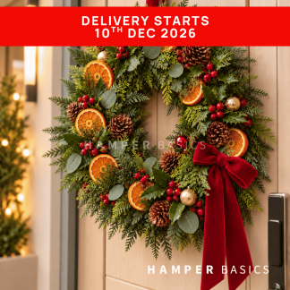 Fresh Christmas wreath decorated with dried orange slices, pine cones, fillers and foliages