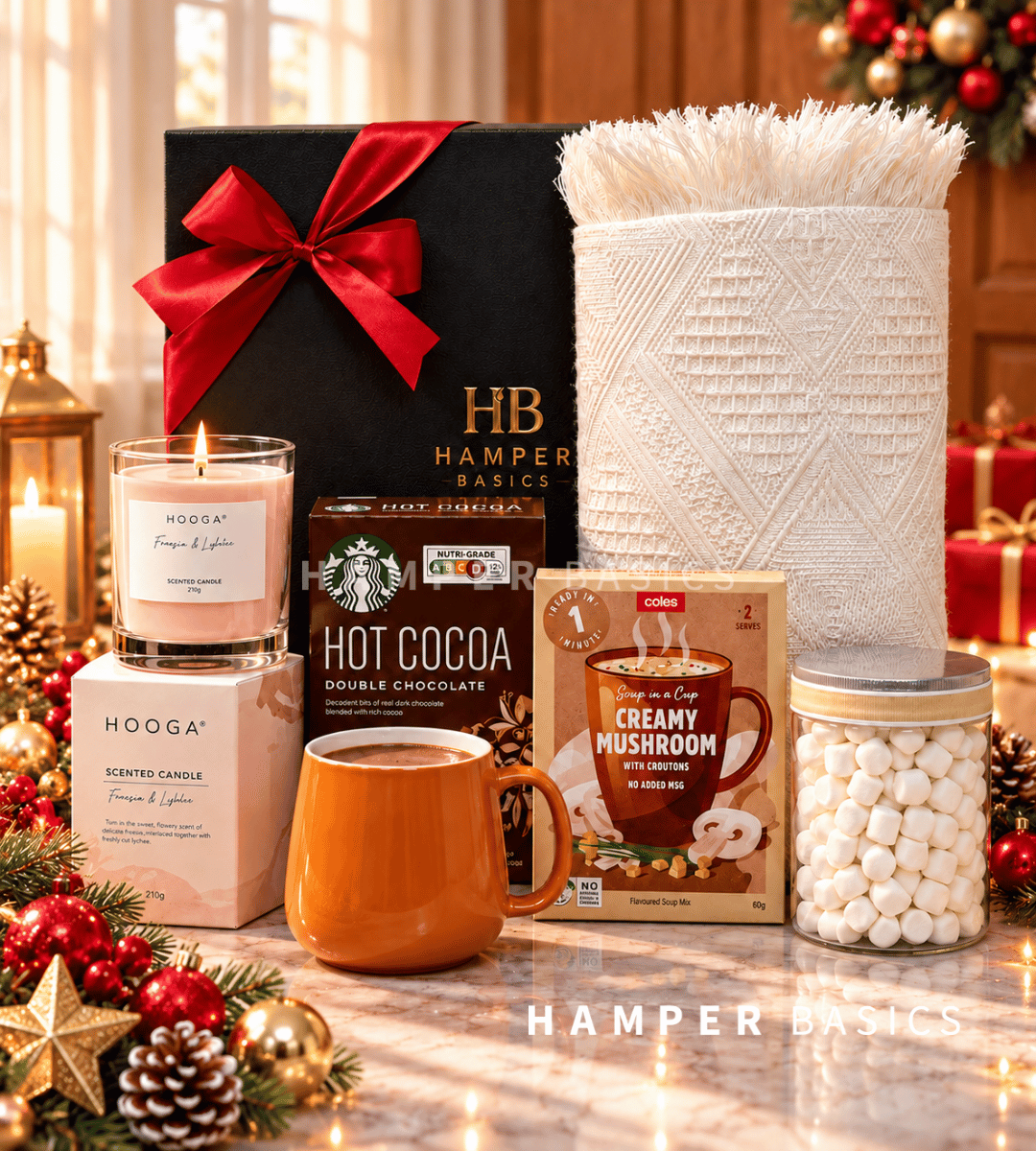 Cosy Christmas hamper with a soft Nordic throw, scented candle, comforting hot cocoa, a stylish mug and sweet marshmallows